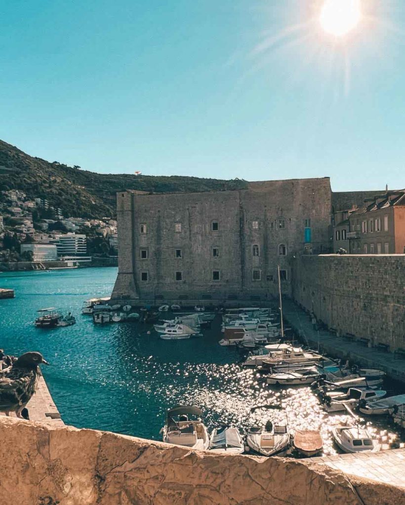 St. John Fortress by Dubrovnik's harbor with boats moored below the City Walls.
